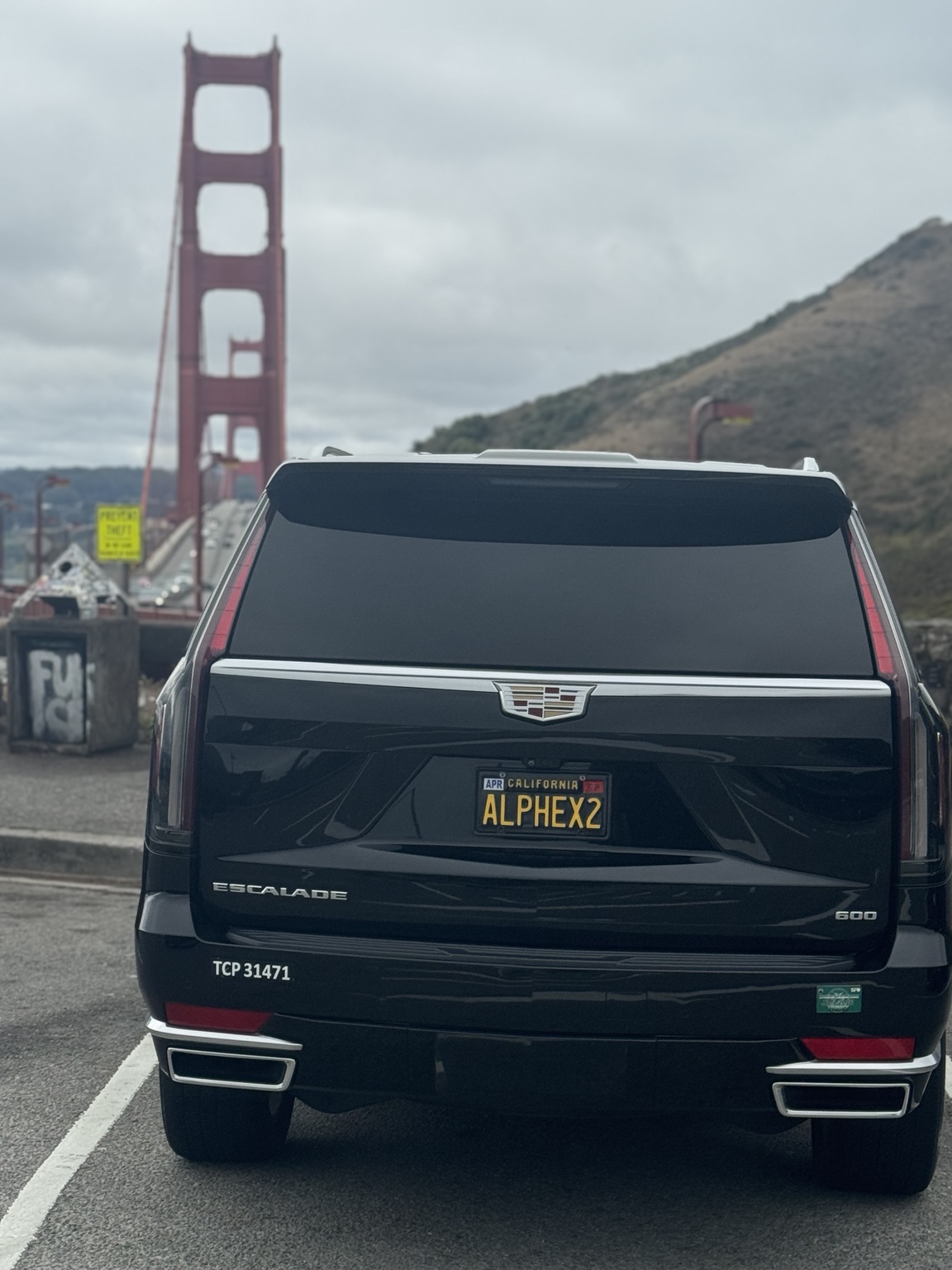 Rear view of a Cadillac Escalade with the Golden Gate Bridge