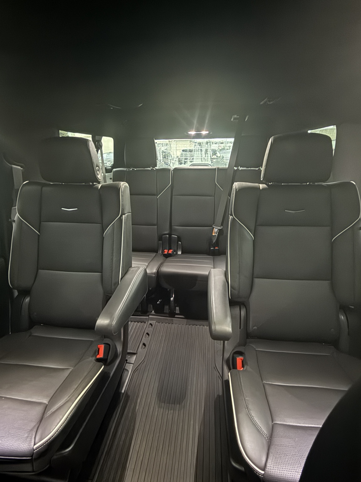 Black leather captain chairs inside a Cadillac Escalade