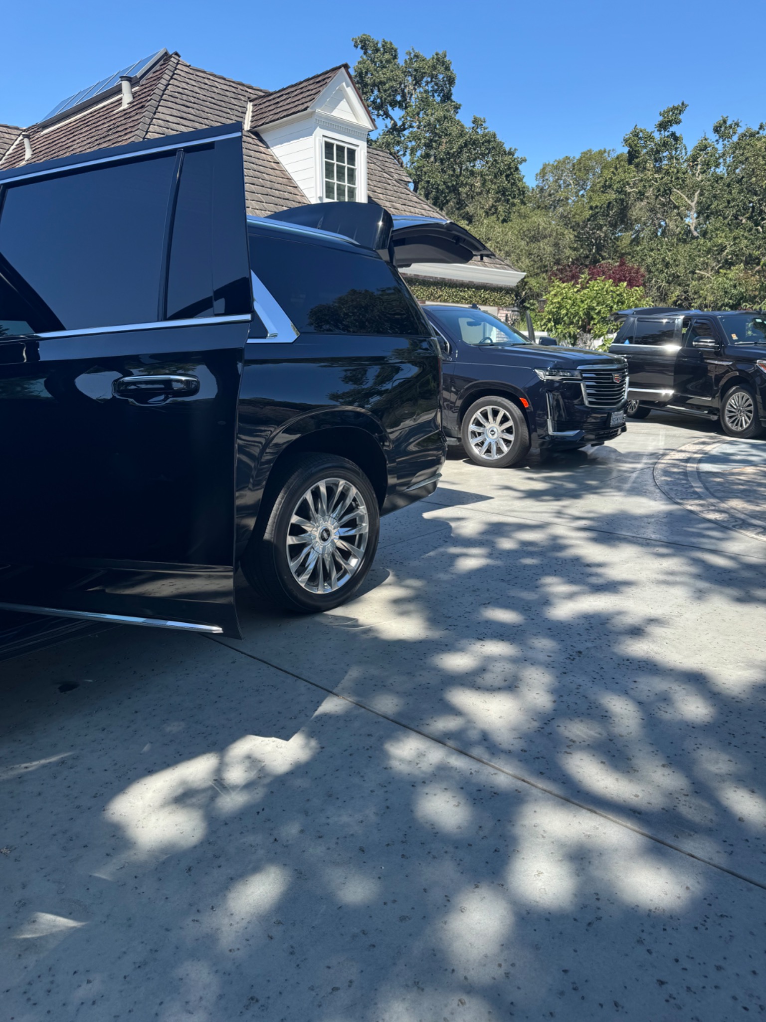 Multiple black Cadillac Escalades prepared for coordinated service