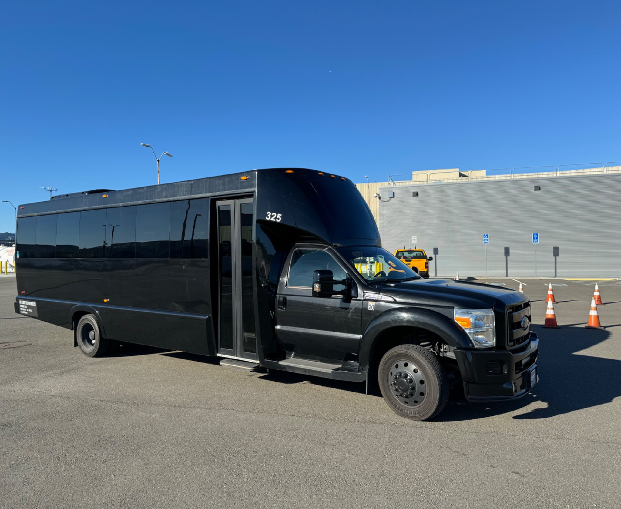 Black executive mini coach ready for group transportation